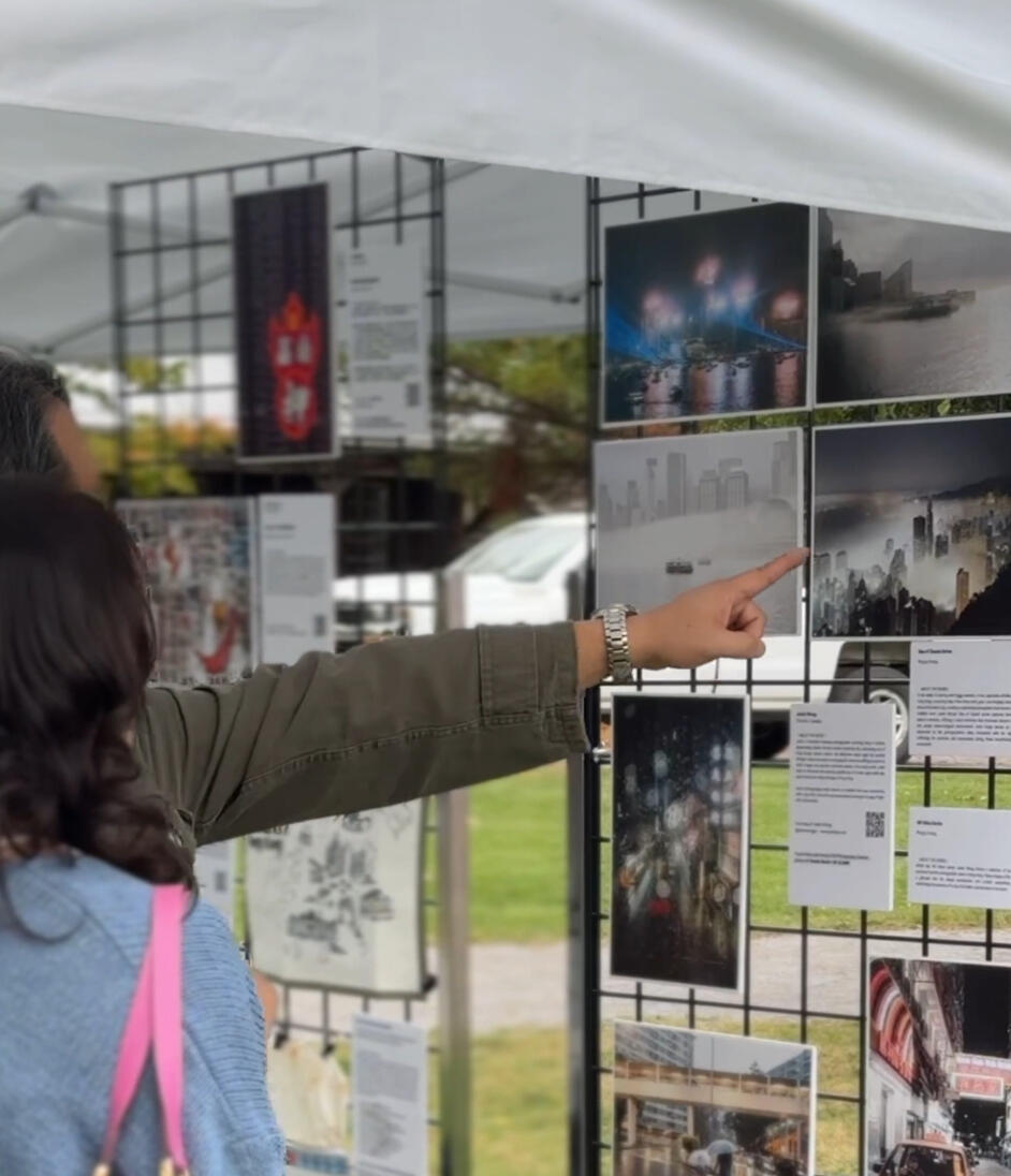 Visitors engaging with featured Urban Poet Justin Wong's citysnaps at 2023 Urban Poet Toronto Exhibition.